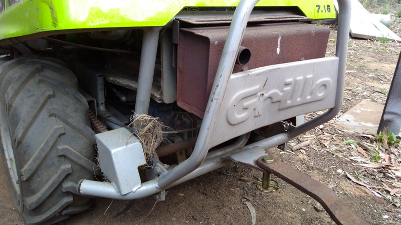 All that grass is caught up on the sprocket of the diff lock axle. The actuator is on the other side...